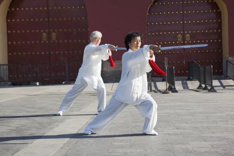 Two old men dancing swords in the park Foto stock