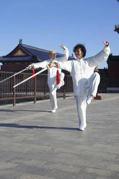 Two old men dancing swords in the park Stock Photos