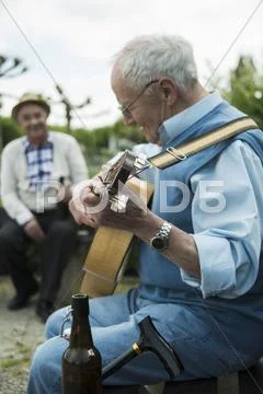 Two Old Men With Guitar In The Park