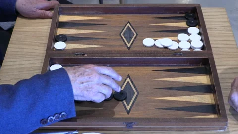 Two old men playing an exotic version of backgammon Stock Footage 196252317