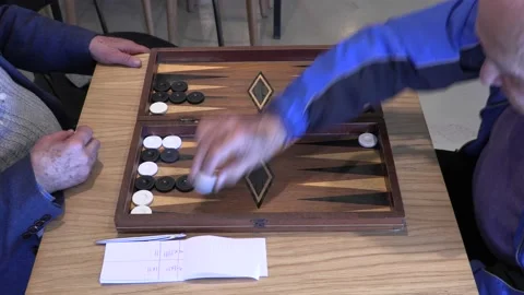 Two old men playing an exotic version of backgammon Stock Footage 196252601