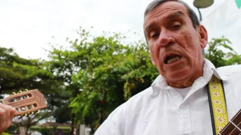 Two old men singing Colombian music Stock Footage 303030757