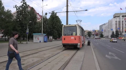 Two old orange trams meet at track turn from mixed traffic to segregation Stock Footage 64638695