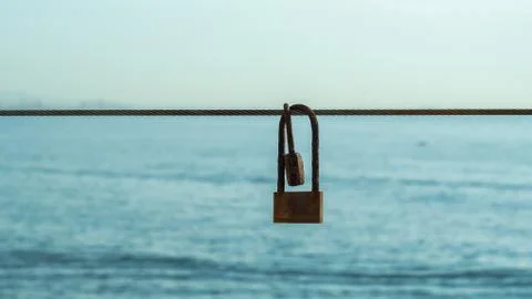 Two old padlocks hanging on a rope sea Stock Photos