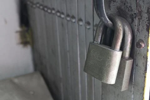 Two Old Padlocks on Iron Gate – Close-up Shot Stock Photos