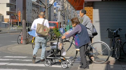 Two old people about to cross the streets in Osaka Japan Stock Footage 124934795