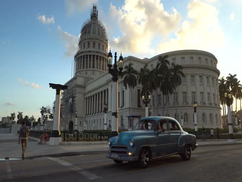 Two old rare retro car is riding near the ancient colonial Capitol building in a Stock Footage 69792598