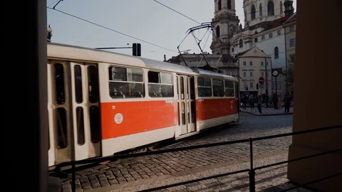 Two old red trams passing through square in Prague 库存影片 115233281