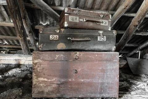 Two Old, Rusty, Dusty and Dirty Suitcases Lying on the Brown Chest in Attic Stock Photos