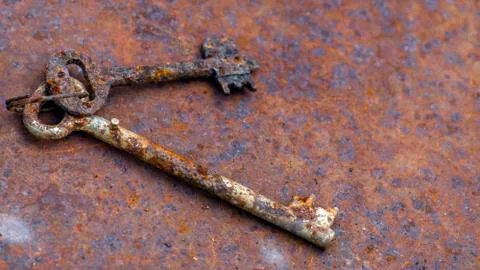 Two old rusty keys on ring shot on steel textured background. Stock Photos