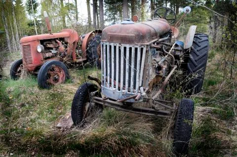 Two old rusty tractor in the forest Stock Photos
