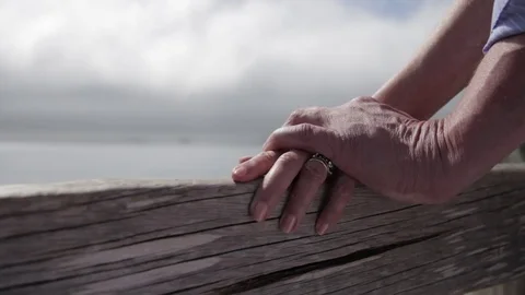 Two old senior couple holding hands at ocean front view Stock Footage 75736246