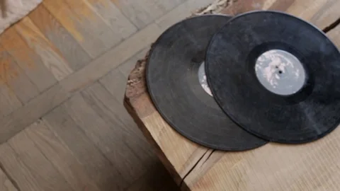 Two old vinyl records lie on the edge of the table top view Stock Footage 102228634