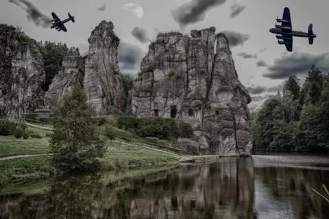 Two old warplanes flying over the Externsteine. Stock Photos
