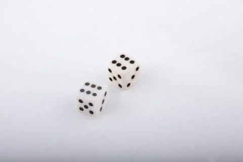 Two old white dice. Isolated on white background. Stock Photos