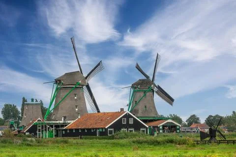 Two Old Windmills and High Clouds in the Blue Sky Stock Photos