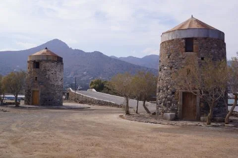 Two old windmills built in stone in Elounda, Eastern Crete (Greece) Stock Photos