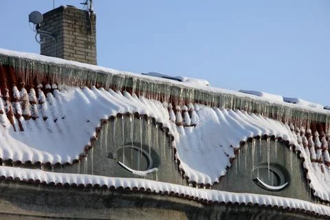 Two old windows with icicles Stock Photos