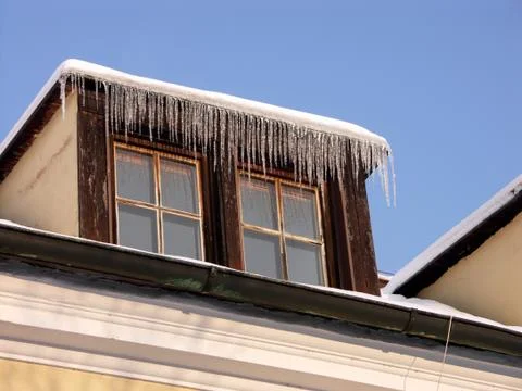 Two old windows with icicles Stock Photos