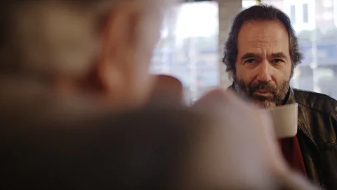 Two older men in conversation over some coffee in a coffee shop Vidéo 102349180
