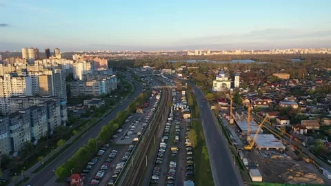 Two one-way roads intersecting with tram lines and a construction site on the Stock Footage 165078222
