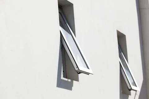 Two open windows on the background of the house Stock Photos