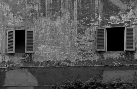 Two open windows in a weathered wall Stock Photos