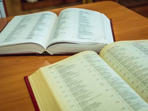 Two opened books on the table reading in the university library Stock Photos