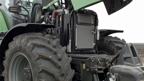 Two operators are examining modern tractor equipment Stock Footage 70082520