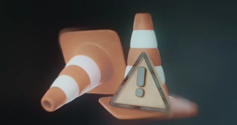 Two orange and white striped traffic cones with a triangular warning sign Stock Footage 314503016