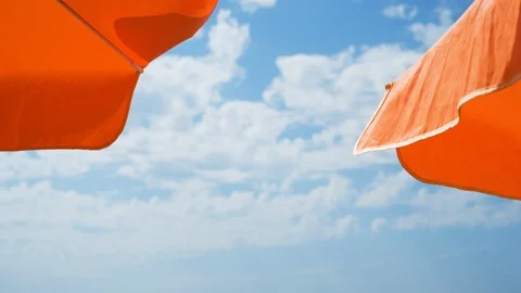 Two orange beach umbrellas Video stock 123554521