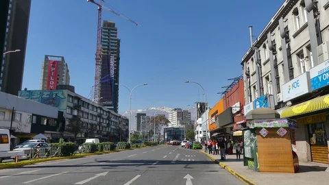 Two orange buses pass by the camera on a large avenue Stock Footage 97222579