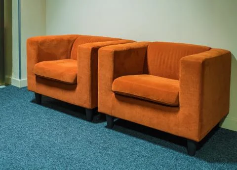 Two orange chairs stand in the corridor of the hotel on Rosa Khutor Stock Photos