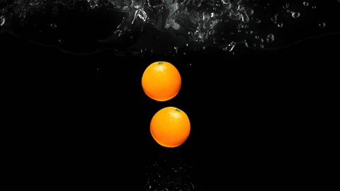 Two orange fallin in water Stock Footage 141122960