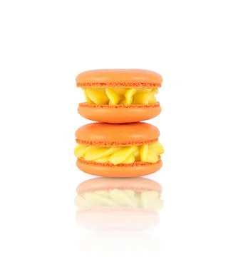Two orange homemade macarons stack isolated on white Stock Photos