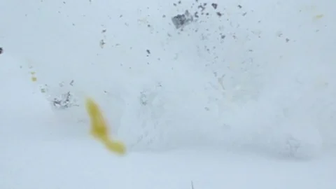 Two orange lie in snow, sad faces drawn on fruits skin, right suddenly explode Stock Footage 84567633