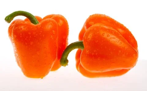 Two orange peppers Stock Photos