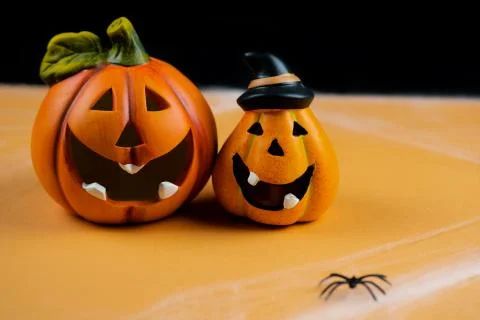 Two orange pumpkins on a black background. Halloween Stock Photos