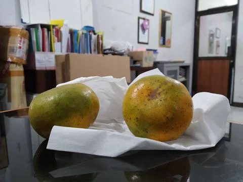 Two oranges on a glass table with a tissue Stock Photos