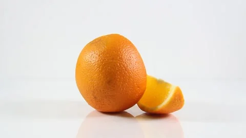 Two oranges sitting on top of a table Stock Footage 130398590