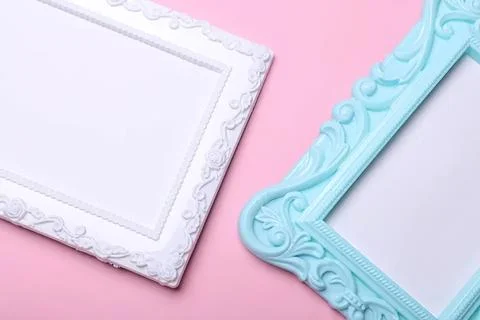 Two ornate empty picture frames on pink background 스톡 사진