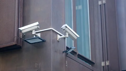 Two outdoor security cameras mounted on building corner providing video sur.. Stock-Footage 332744772