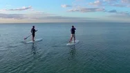 Two Paddleboarders At Sunset By Aerial Drone Stock Footage