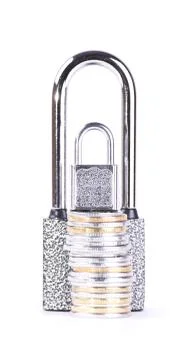 Two padlocks and a stack of coins Stock Photos