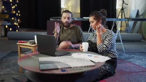 Two painters are watching something on the computer Stock Footage 155907099
