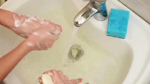 Two pair of hands over the sink. Close up view. Girls carefully wash hands with Stock Footage 126289872