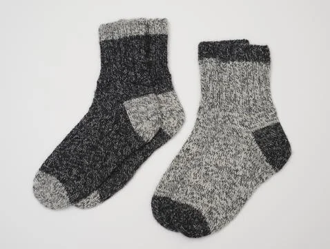 Two pair of knitted wool socks in two shades of grey Stock Photos