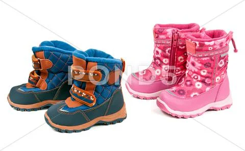Two pairs of baby blue and pink boots Stock Photos