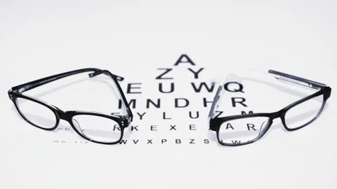 Two pairs of glasses on the table for vision check in black and white Stock Photos