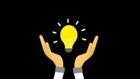 Two pairs of hands cup a glowing yellow light bulb with a black background. Video stock 334660666